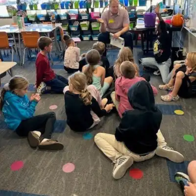 Image of a volunteer talking to students